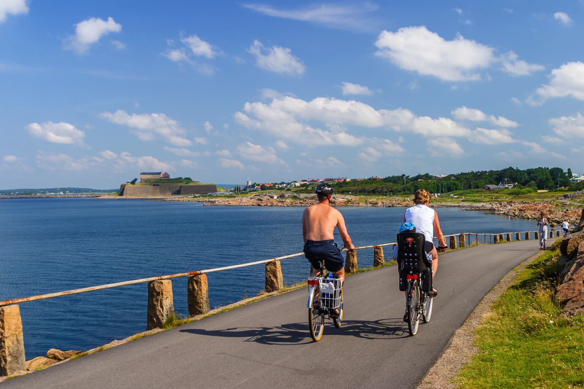 Family cycling along the sea