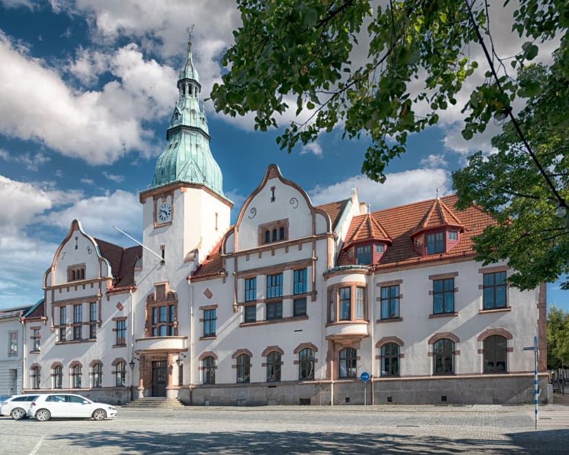 Old town hall building under a blue cloudy sky