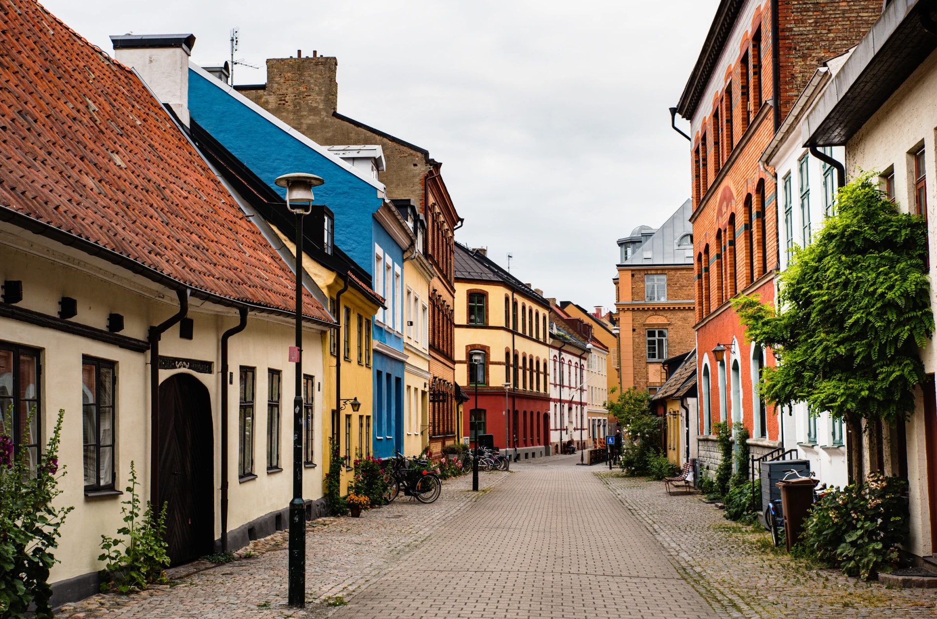 Historical alley with typical Swedish houses in Malmo Gamla Stan, Malmö old town. Swedish cobbled alleyway with bicycles shows the Nordic architecture