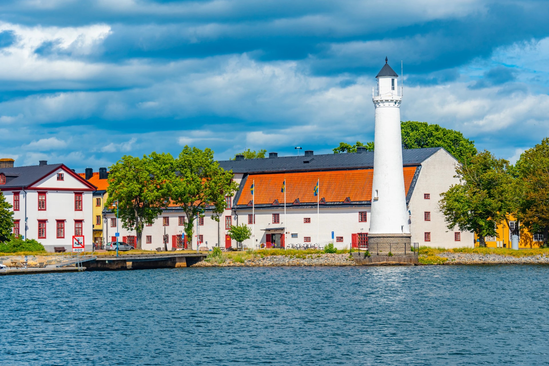 Lighthouse at traditional port buildings in Karlshamn, Sweden.