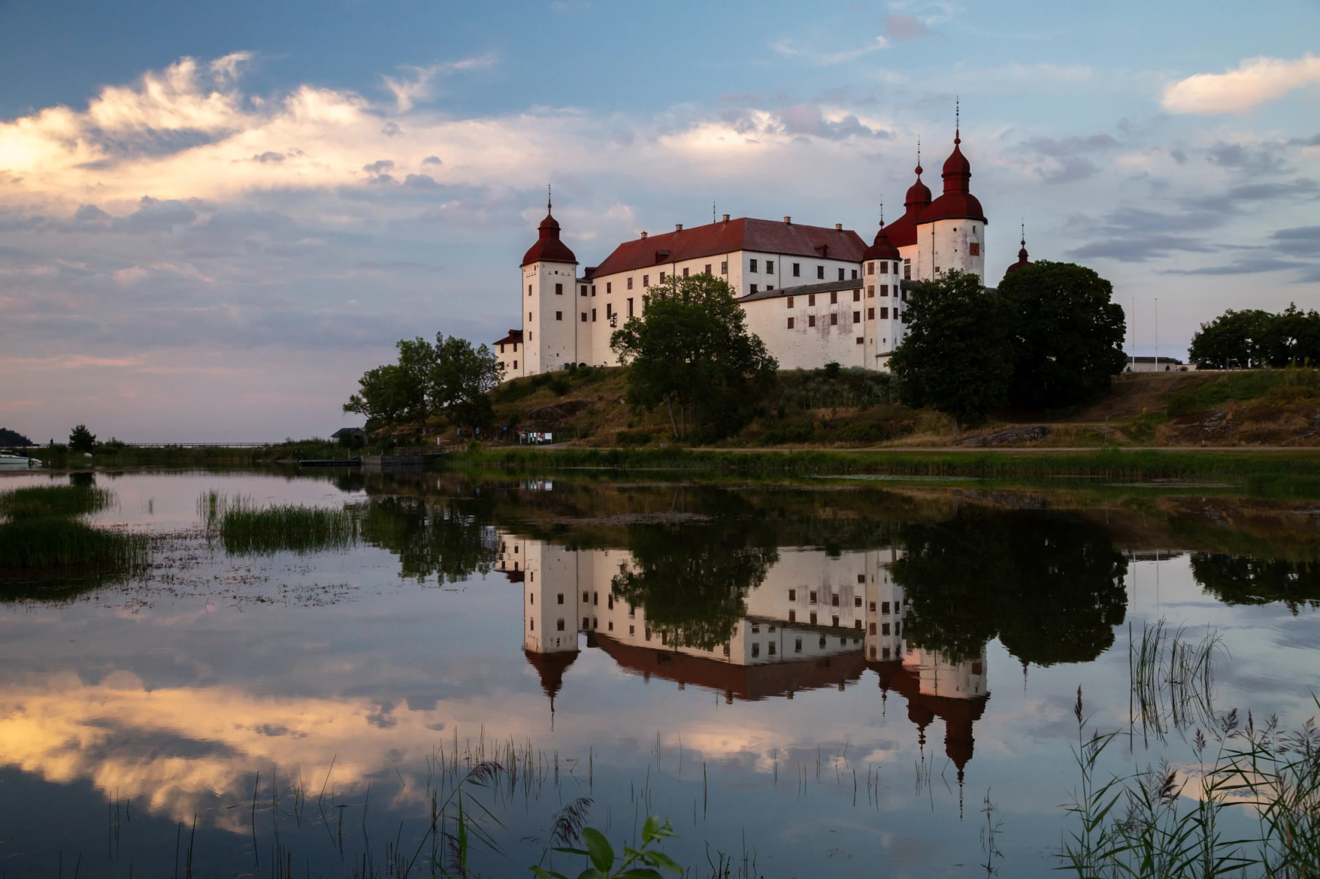 Evening shot of Lacko castle with reflection in the mirror like water of lake Vanern, Lidköping, Sweden
